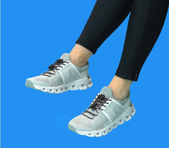 Allen's Bootery Xpand Laces black reflective quick release system installed on grey athletic sneakers
