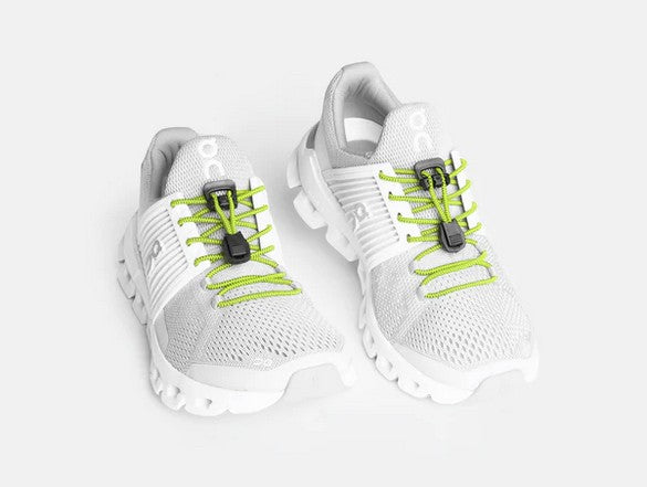 Allen's Bootery Xpand lemon lime elastic quick release laces installed on white athletic running shoes