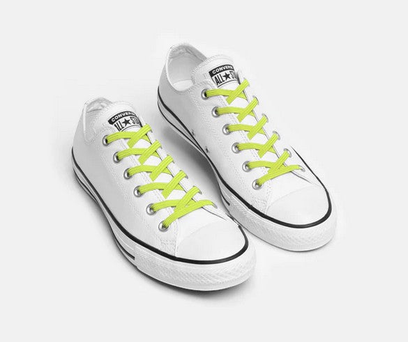 Allen's Bootery Xpand Laces Original in bright lemon lime installed on white low-top sneakers for a no-tie fit.