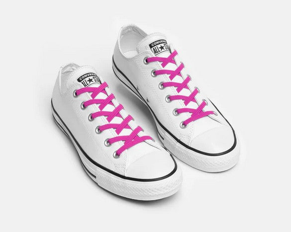 Allen's Bootery Xpand Laces Original no-tie elastic laces in vibrant magenta installed on white canvas sneakers.