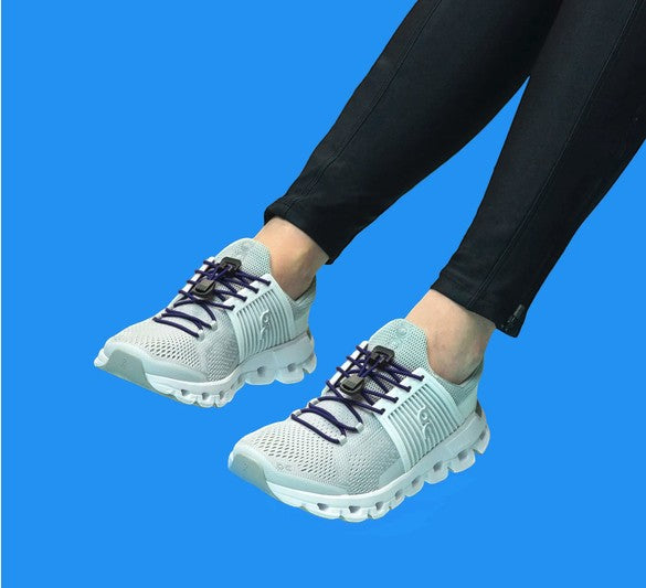 Allen's Bootery Xpand navy blue elastic quick release laces installed on light grey athletic sneakers