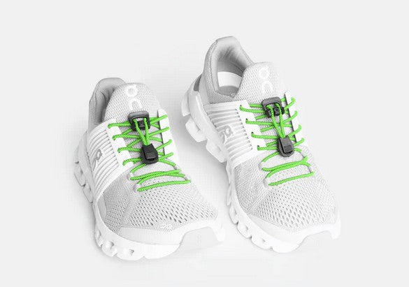 Allen's Bootery Xpand neon green elastic quick release laces installed on white athletic sneakers
