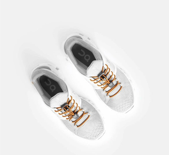 Allen's Bootery Xpand neon orange elastic quick release laces installed on white athletic sneakers