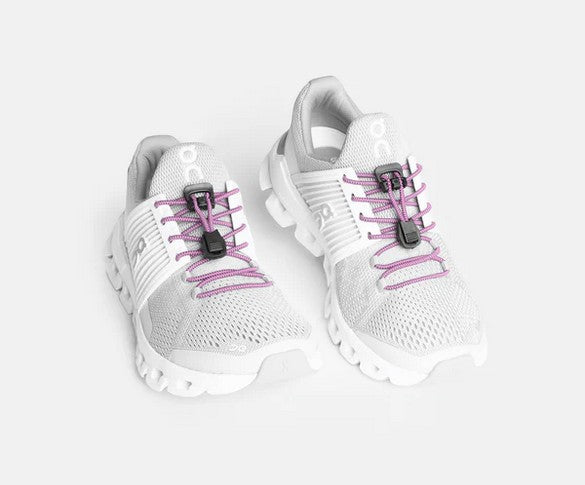 Allen's Bootery Xpand soft pink elastic quick release laces installed on white athletic sneakers