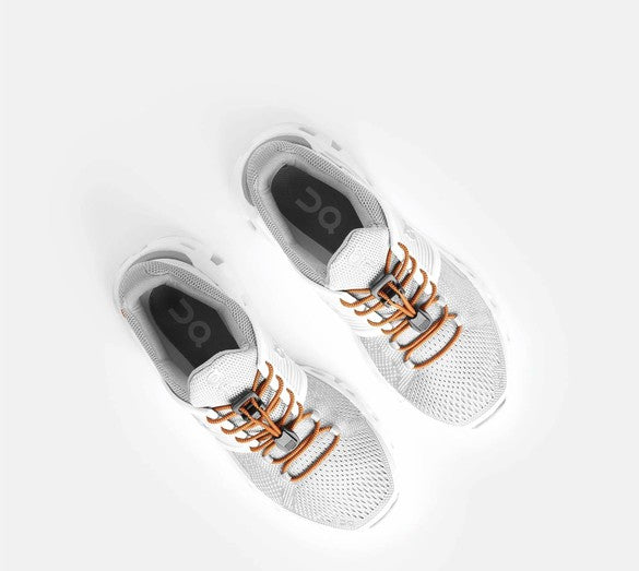 Allen's Bootery Xpand quick release elastic laces in pumpkin orange installed on white athletic sneakers