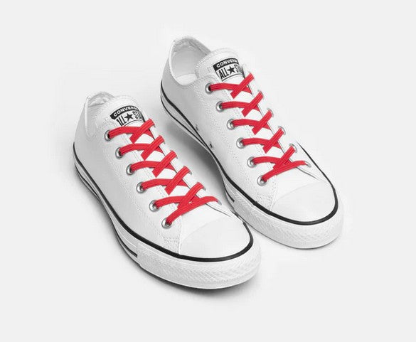 Allen's Bootery Xpand red elastic no-tie laces installed on white low-top canvas sneakers