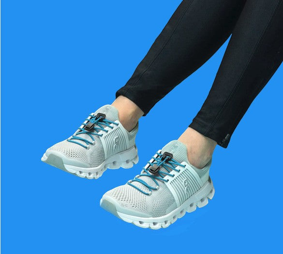 Allen's Bootery sky blue Xpand quick release elastic laces installed on grey mesh running shoes
