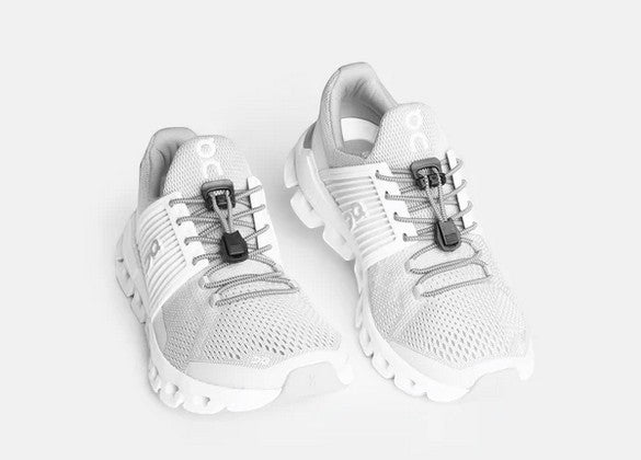 Allen's Bootery Xpand quick release steel elastic laces installed on white athletic sneakers
