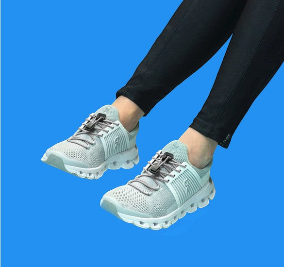 Allen's Bootery Xpand quick release steel elastic laces installed on light grey athletic sneakers