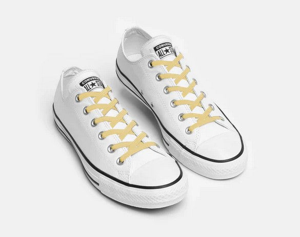 Allen's Bootery Xpand Laces Original in sunshine yellow installed on white low-top canvas sneakers
