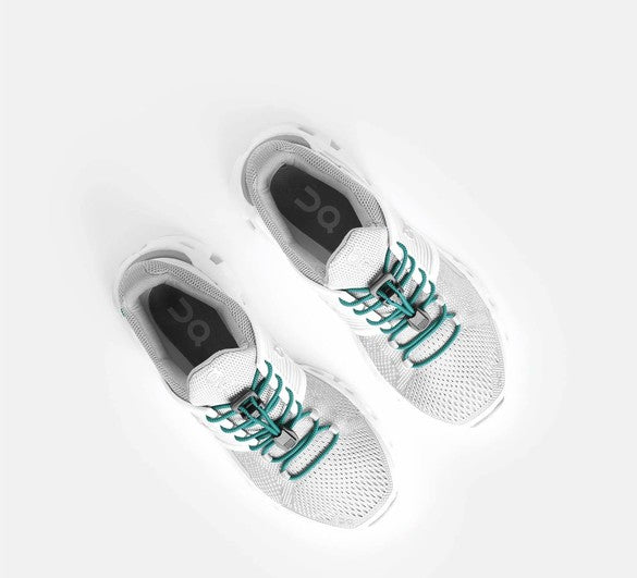 Allen's Bootery Xpand teal elastic quick release laces installed on white athletic sneakers