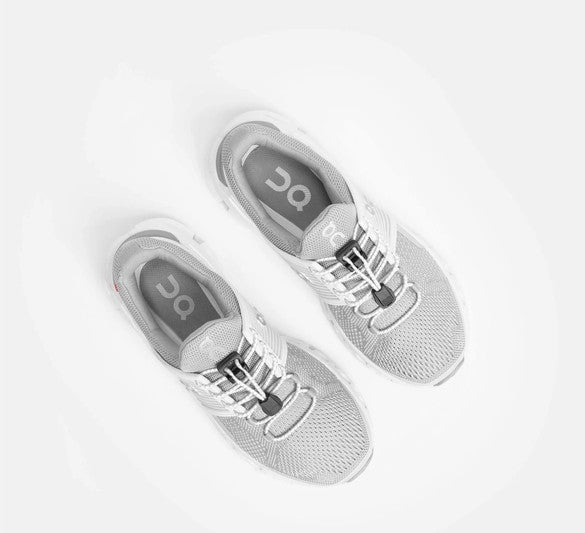 Allen's Bootery Xpand white reflective elastic quick release laces installed on grey athletic sneakers