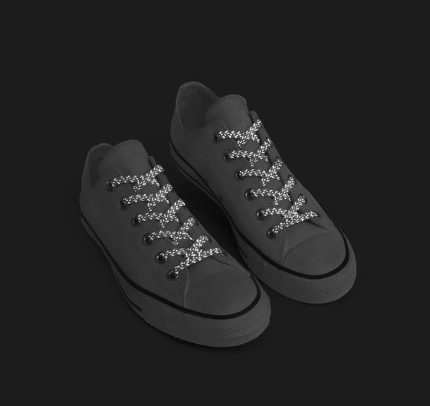 Allen's Bootery Xpand white reflective no-tie elastic laces installed on a pair of low-top sneakers