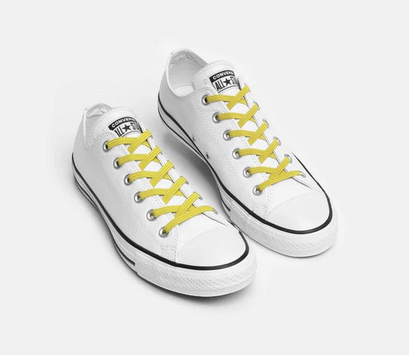 Allen's Bootery Xpand yellow elastic no-tie laces installed on a pair of white low-top canvas sneakers